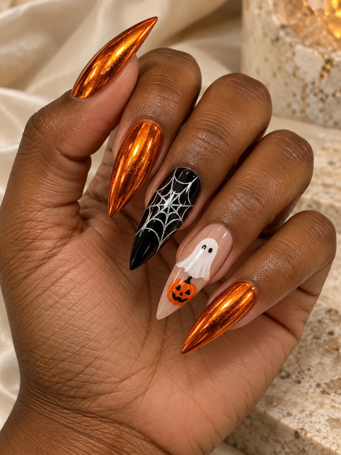 Halloween chrome nails: Stiletto · copper, ghost & web. Copper-orange chrome, a ghost, a pumpkin and a delicate web.