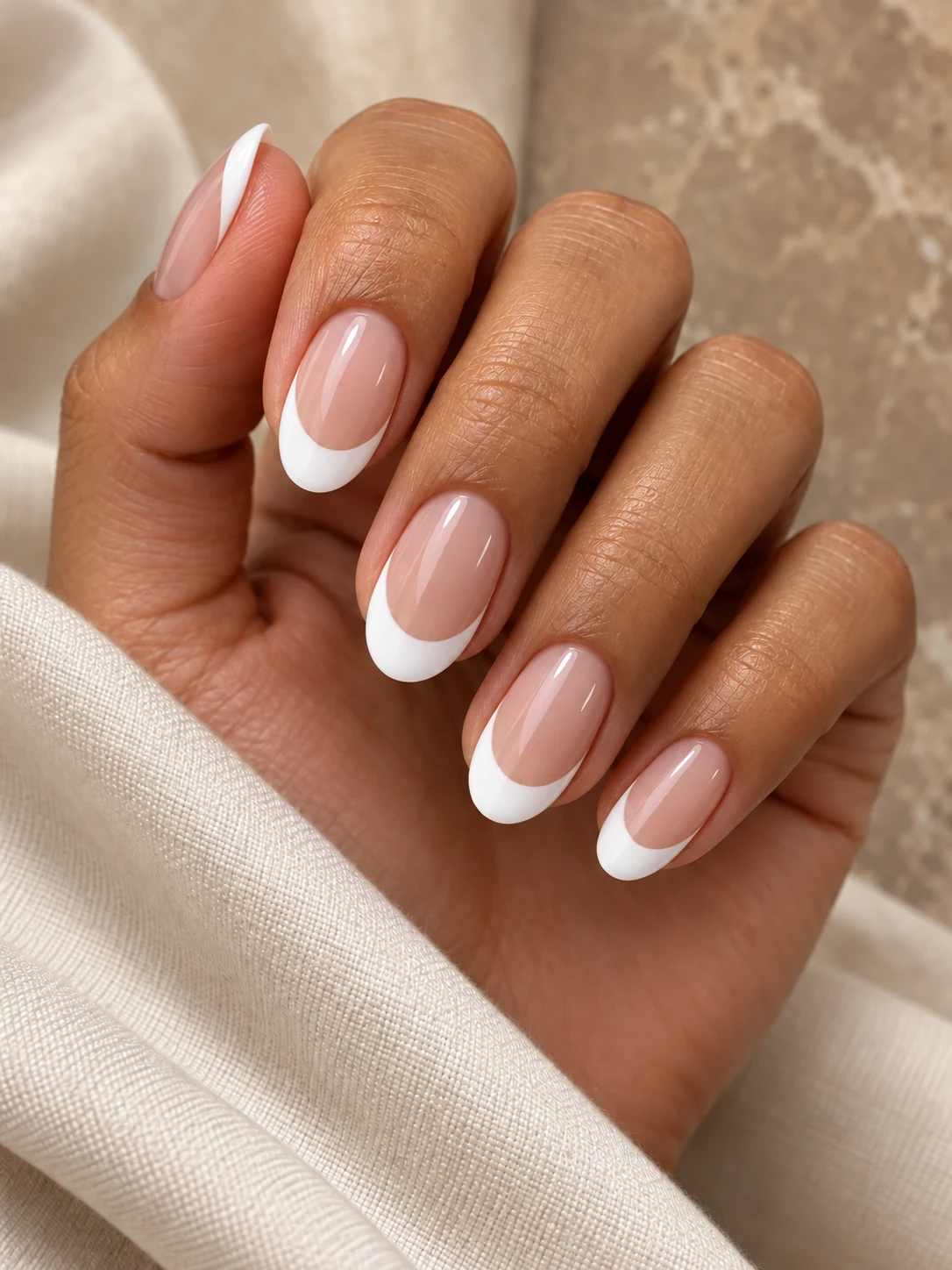Soft Deep: medium oval nails with glossy white French tips and nude-pink centers